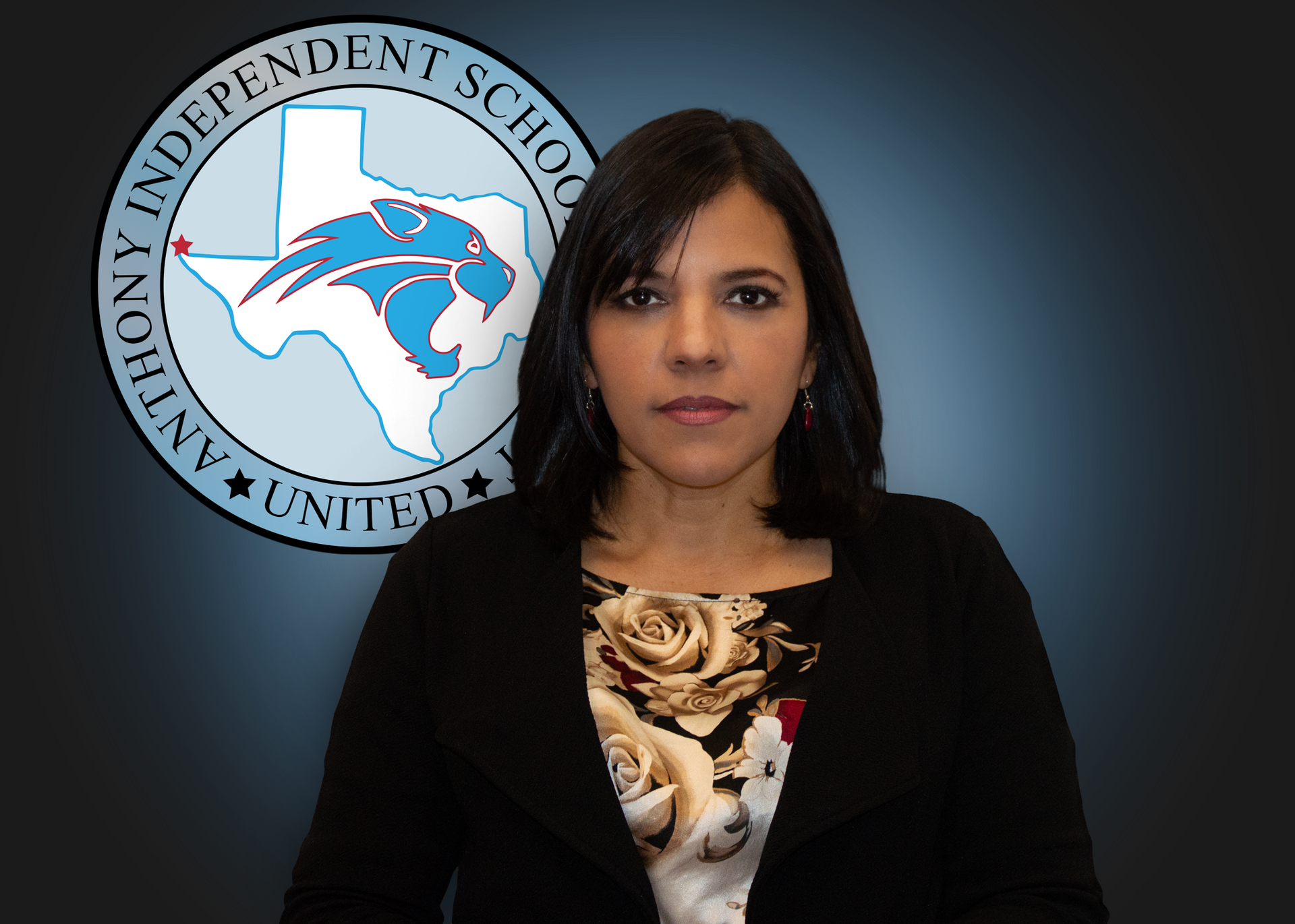 A woman is standing in front of a logo for anthony independent school