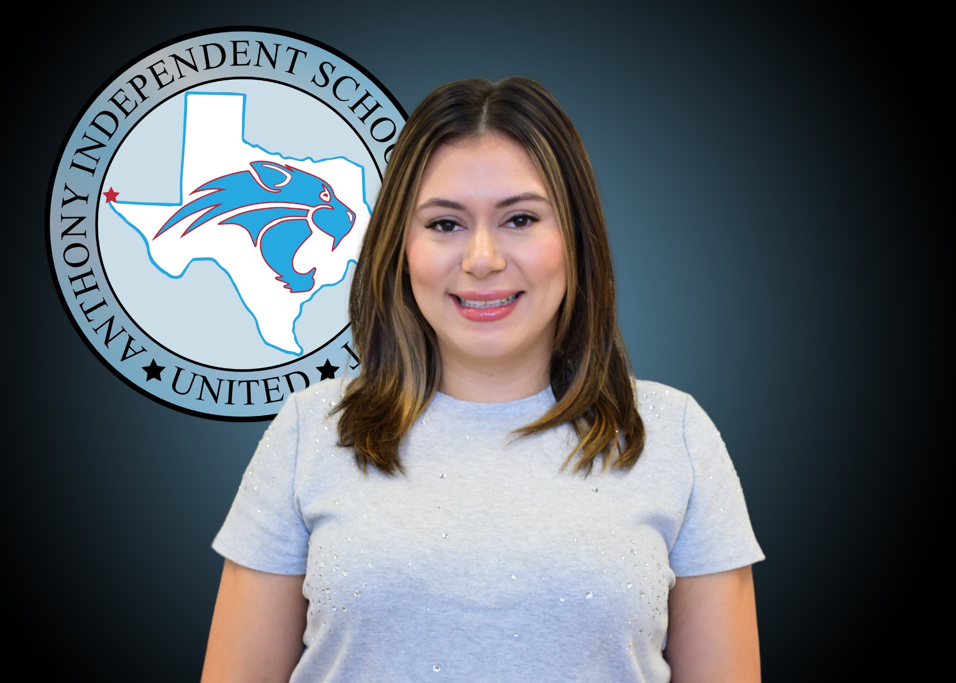 Woman smiling standing in front of Anthony Independent School District logo