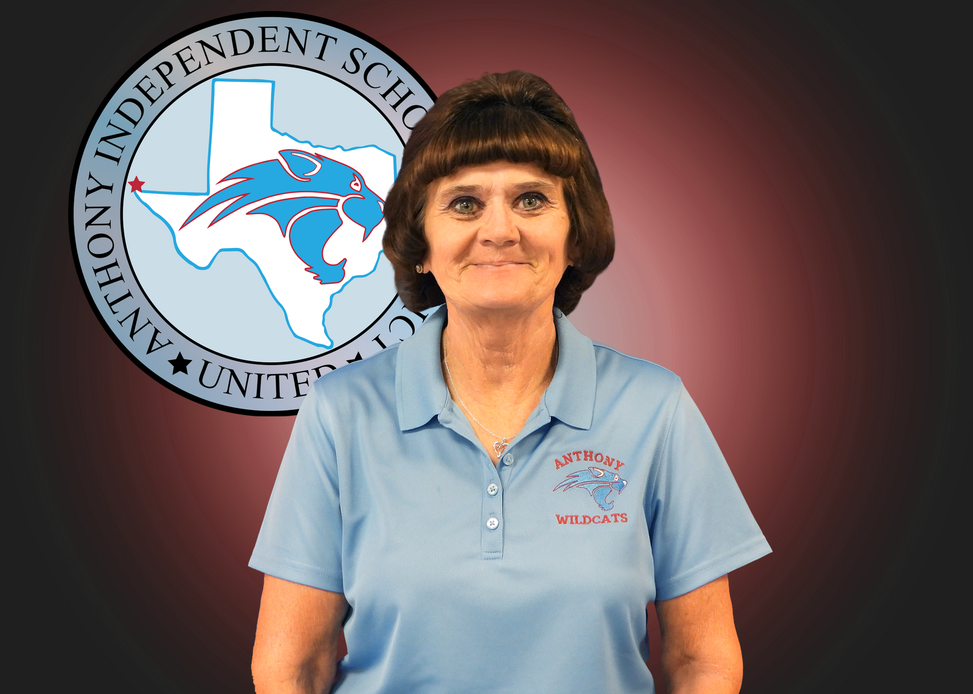 A woman in a blue polo shirt is standing in front of an anthony independent school logo.