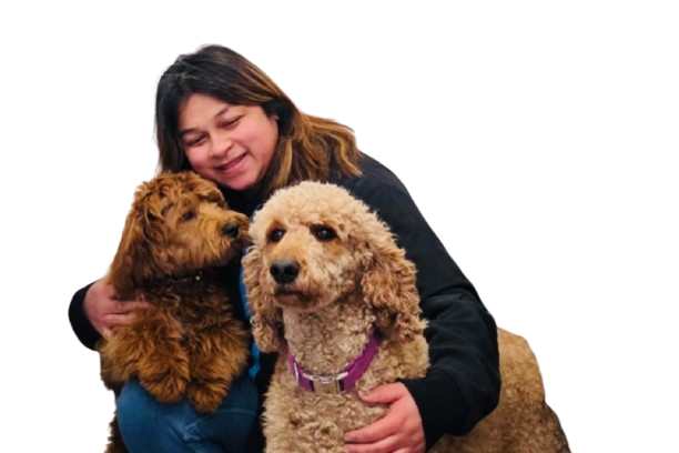 A small dog is taking a bath in a wooden bucket.