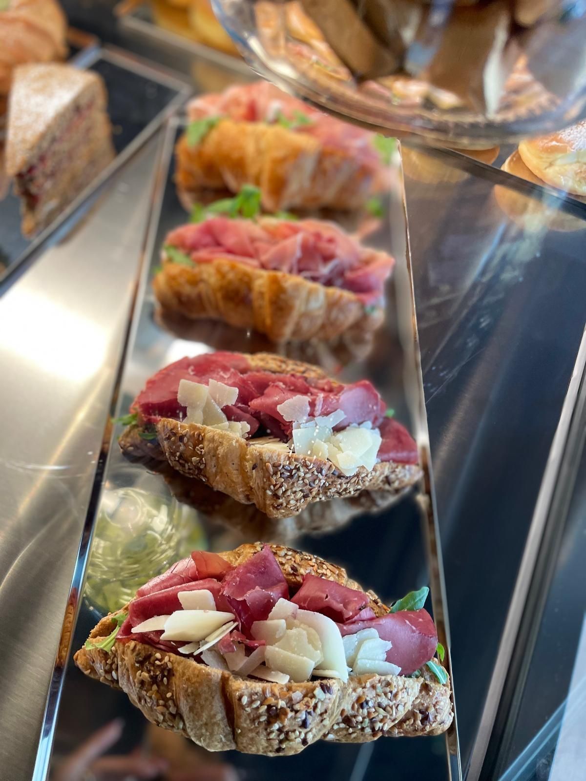 Una fila di panini seduti sopra una teca di vetro.