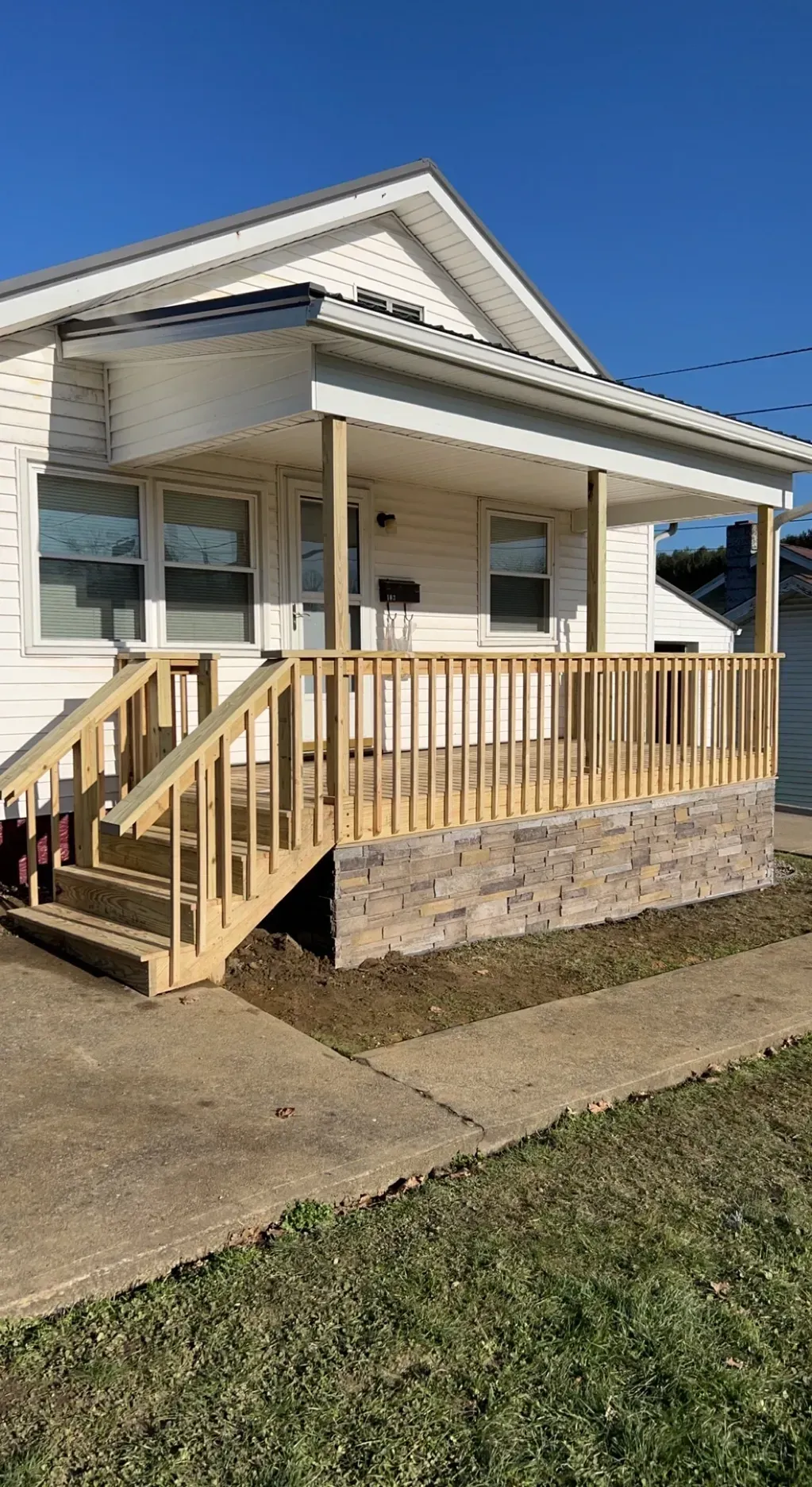 A White House With A Wooden Deck And Stairs - Salineville, OH - Eastern Ohio Builders LLC
