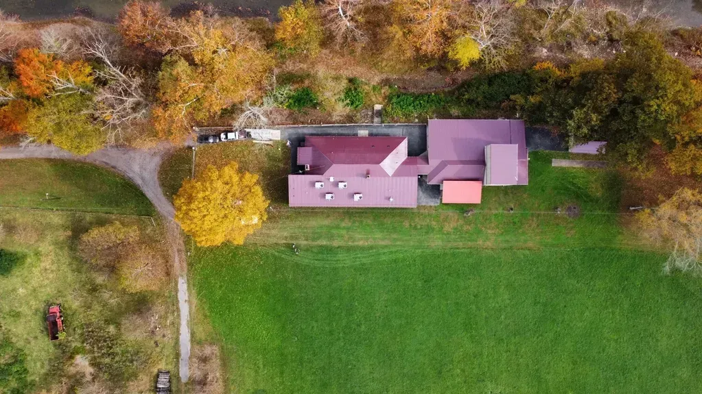 An Aerial View of A House in The Middle of A Field Surrounded by Trees - Salineville, OH - Eastern Ohio Builders LLC
