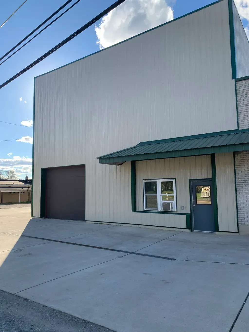 A Large White Building with A Green Roof and A Door - Salineville, OH - Eastern Ohio Builders LLC
