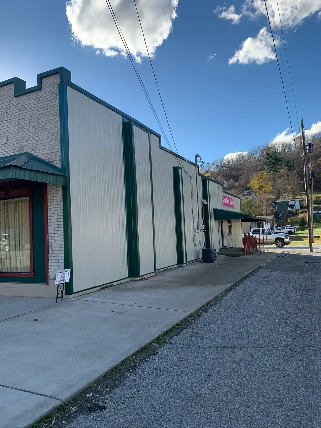 A White Building with Green Trim Is Sitting on The Side of A Road - Salineville, OH - Eastern Ohio Builders LLC