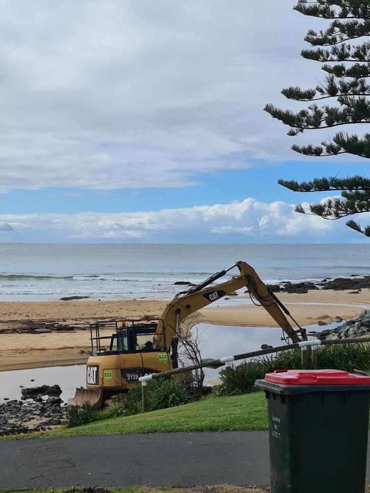 Excavator Moving Rocks On Beach — Projects in Coopernook, NSW