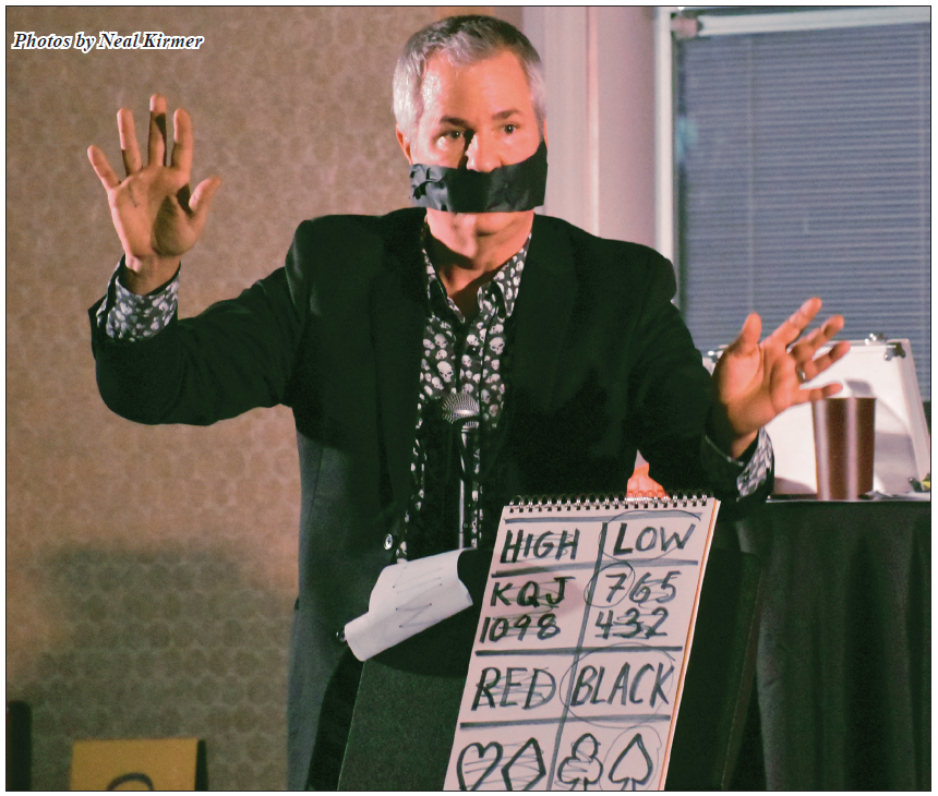 A man with tape on his mouth is holding a sign that says high low and red black