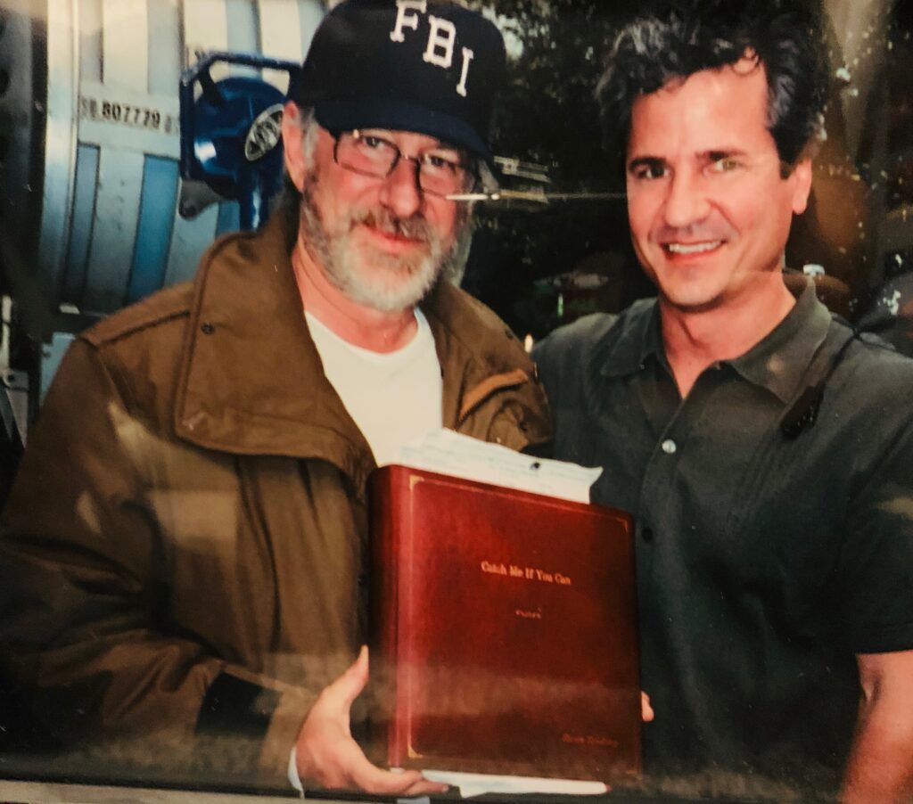 A man wearing a fbi hat stands next to another man