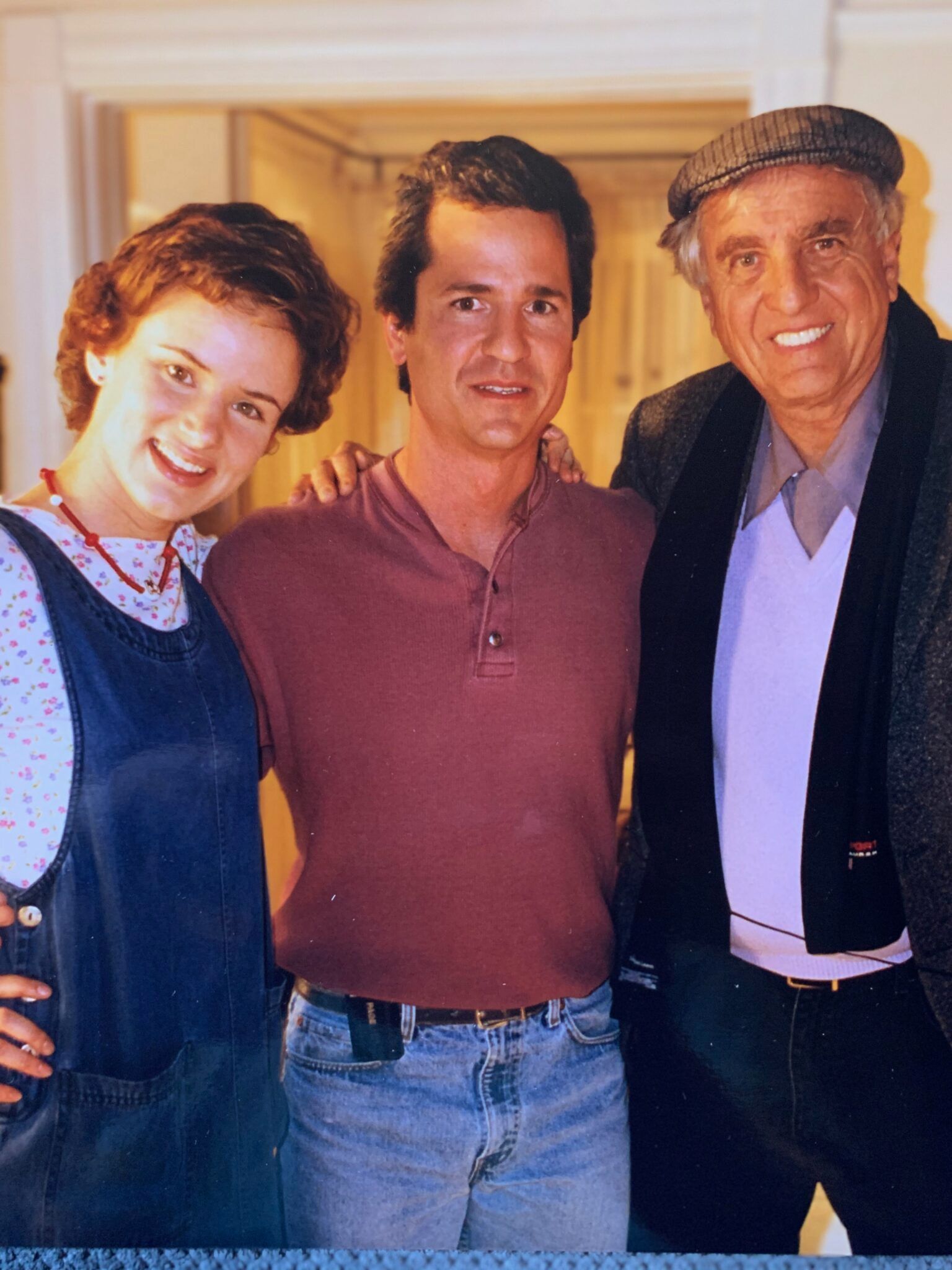 Two men and a woman pose for a picture together