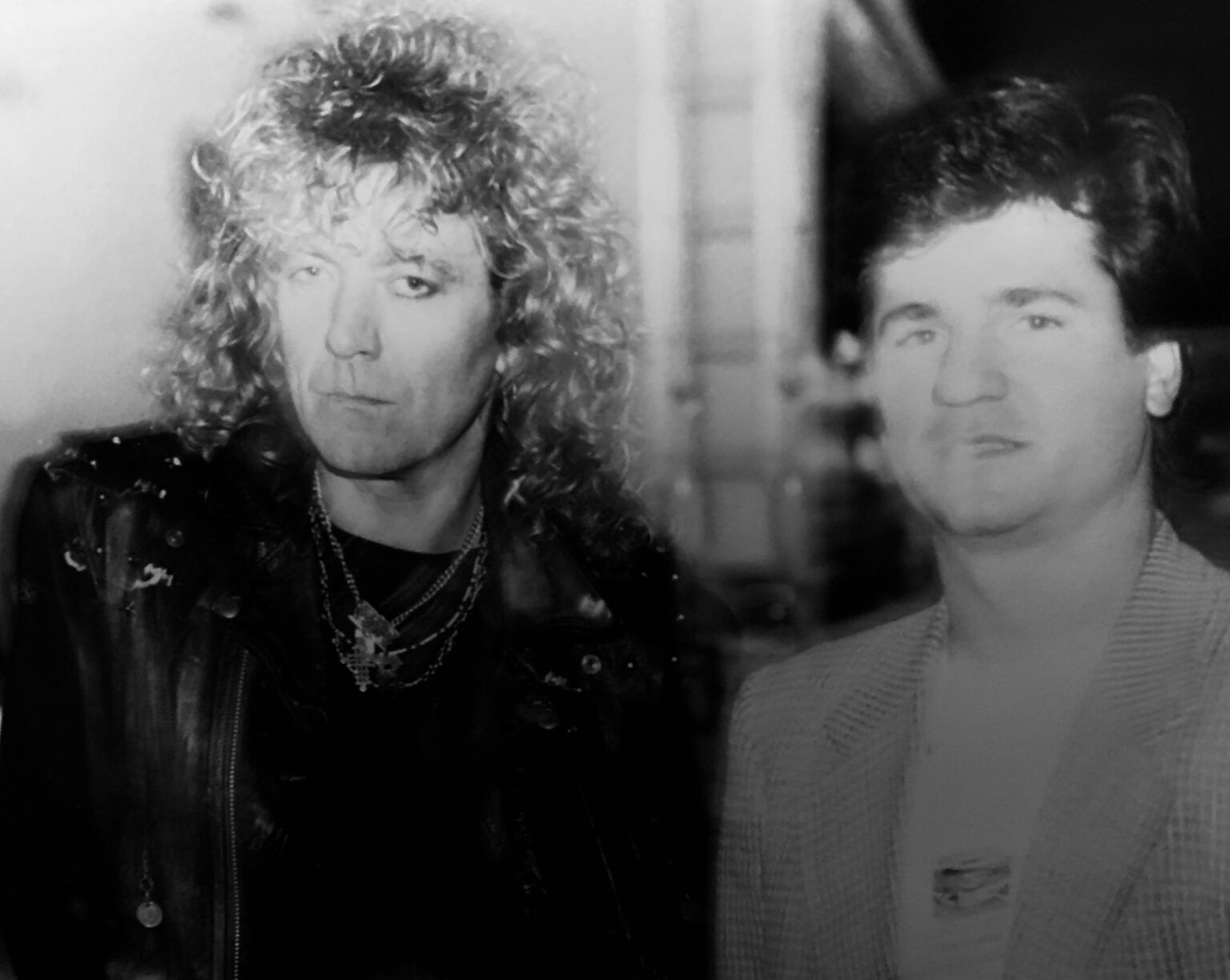 A black and white photo of two men standing next to each other.