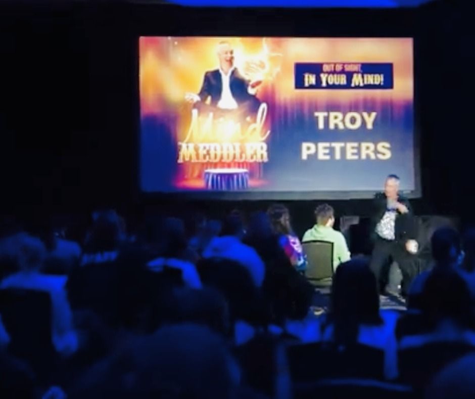 Troy peters is giving a speech in front of a crowd