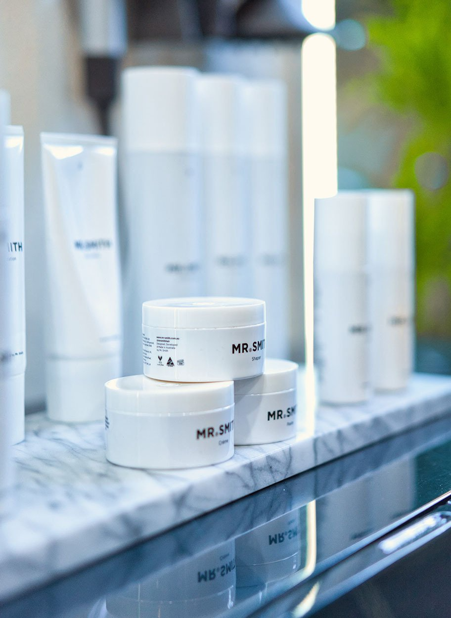 Mr Smith hair styling products on top of white marble plate on blue credenza