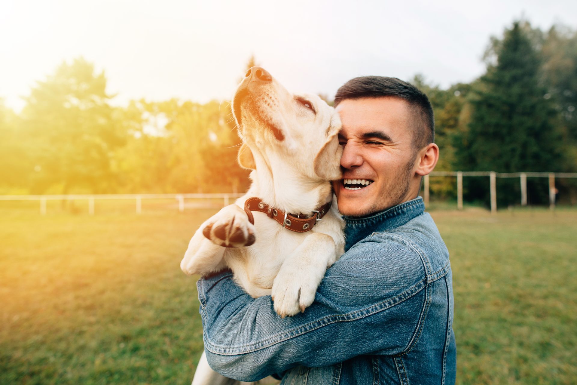 man hugging a dog