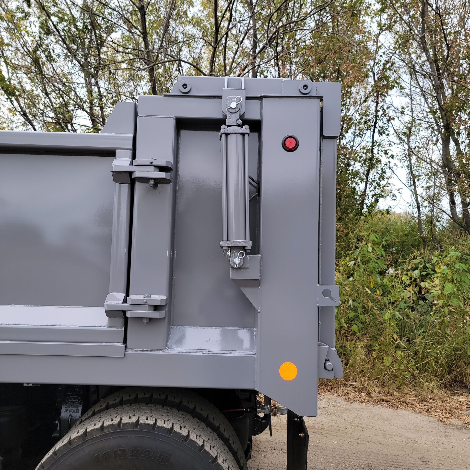 A dump truck is parked on the side of a road.
