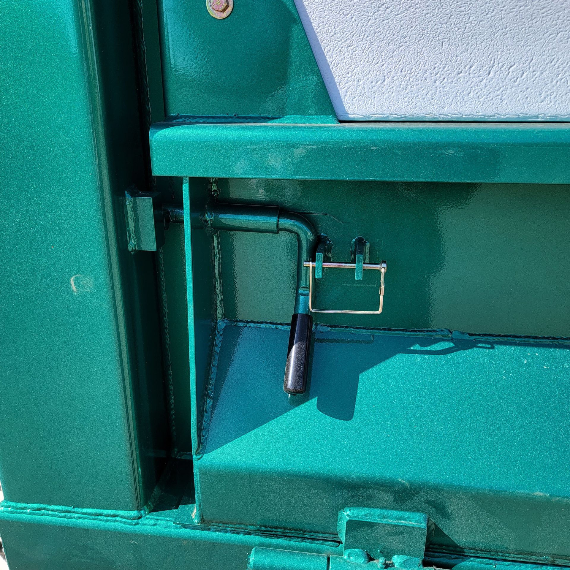 A green door with a black handle on it