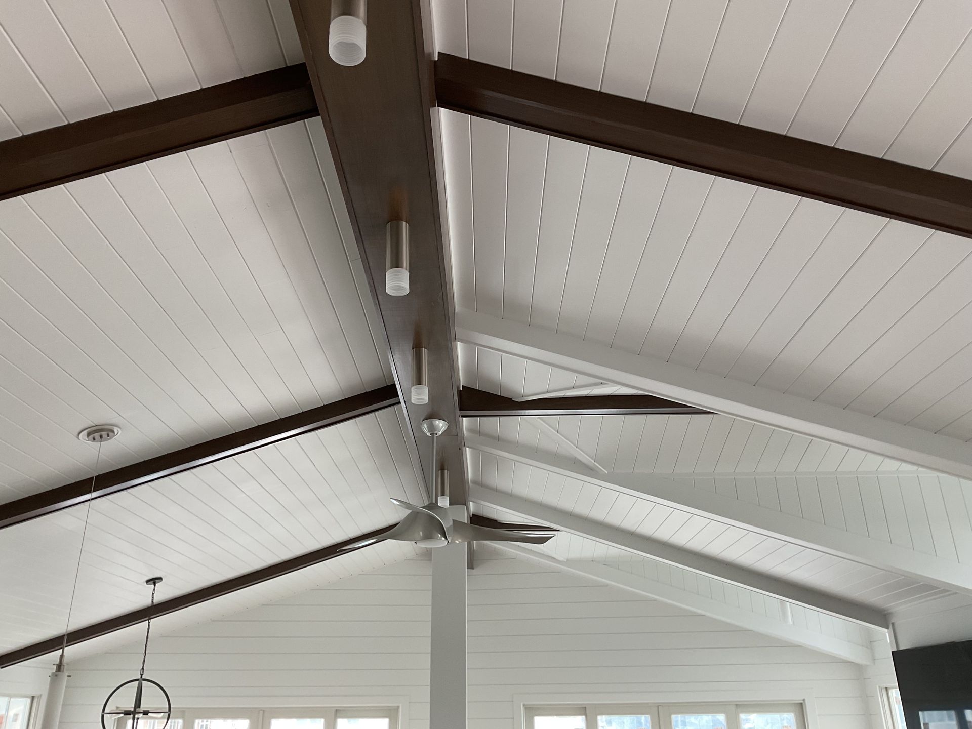 A ceiling fan is hanging from the ceiling of a house.