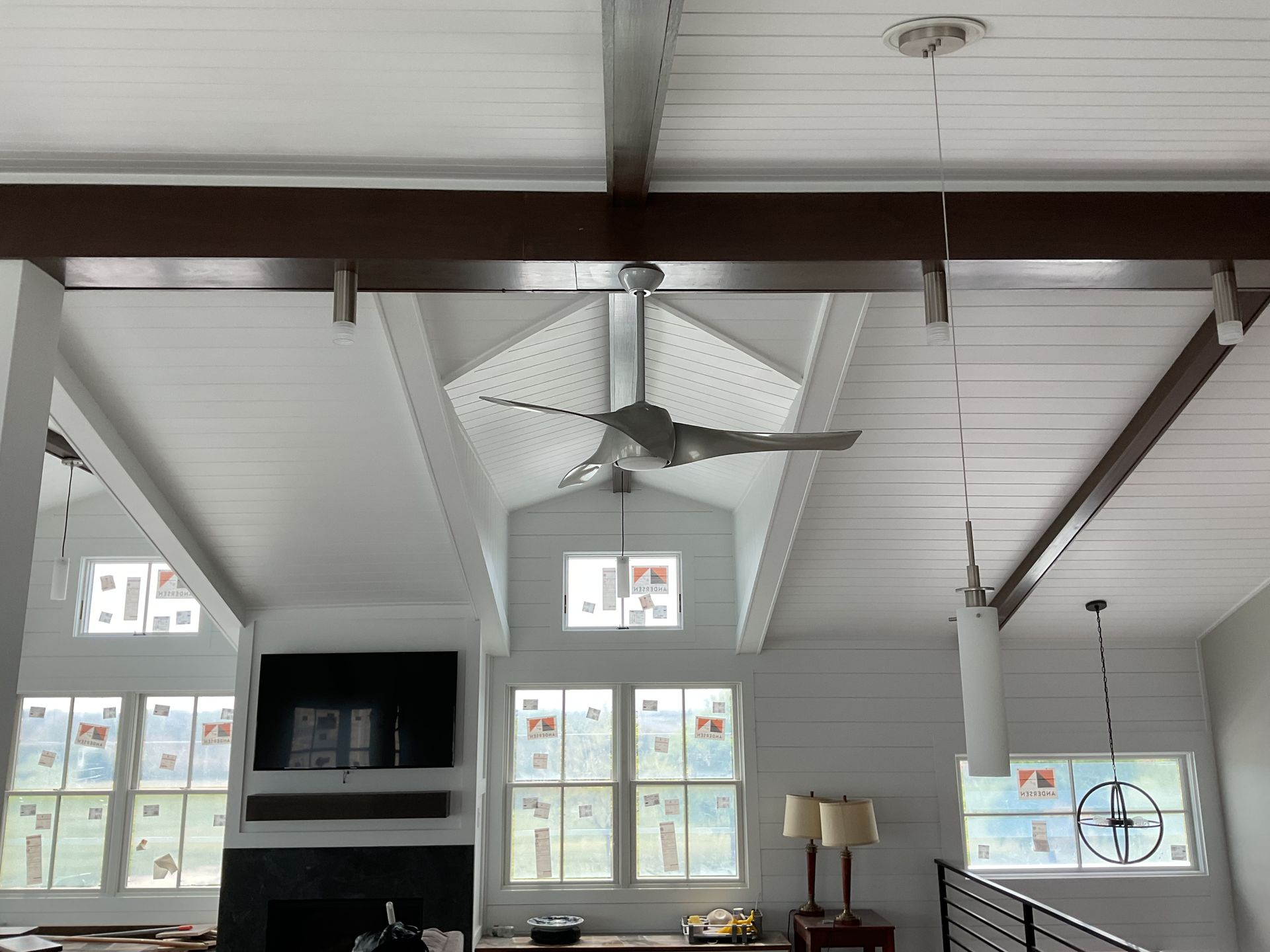 A living room with a vaulted ceiling and a ceiling fan