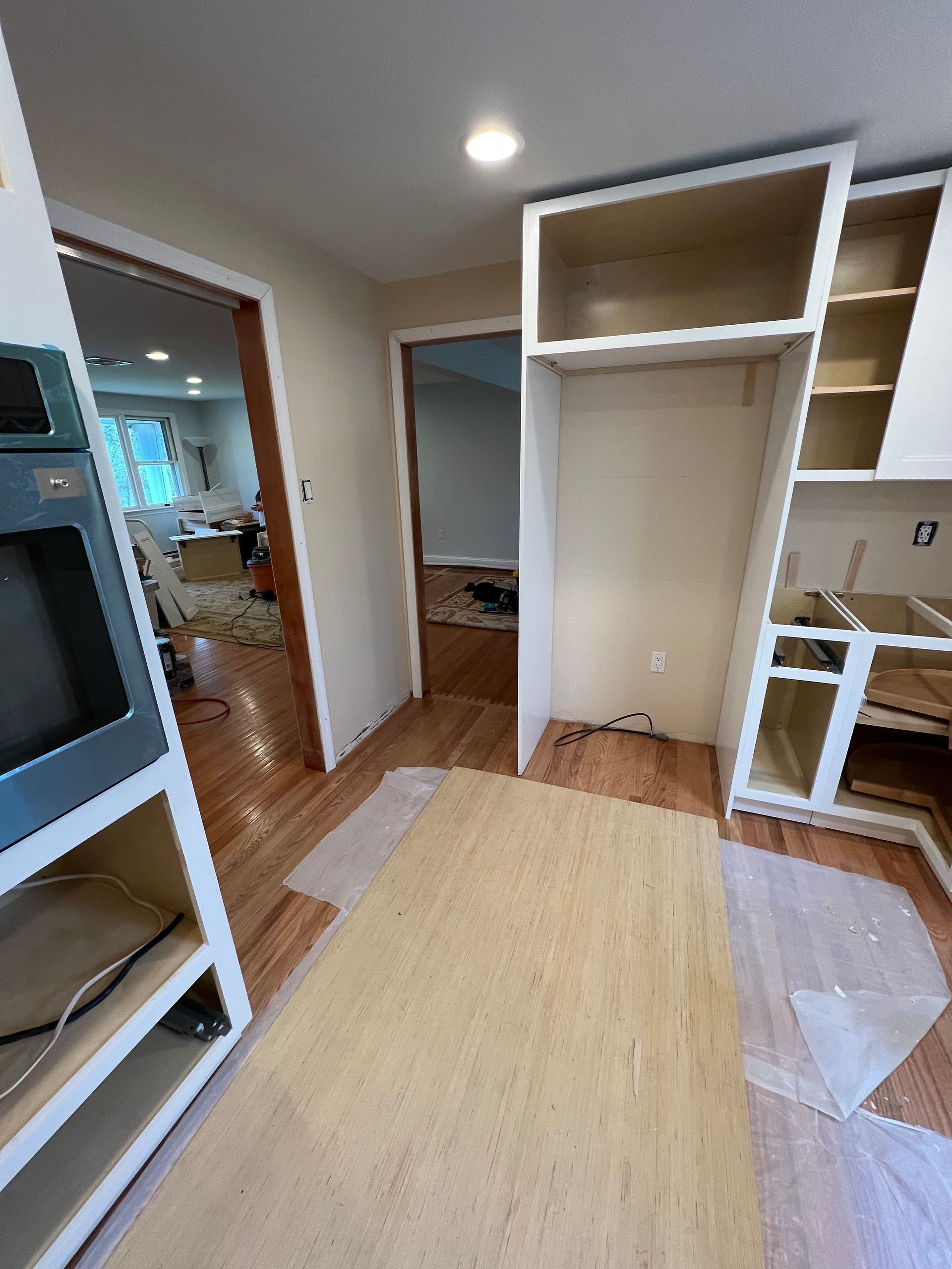 A room with a lot of cabinets and a rug on the floor.