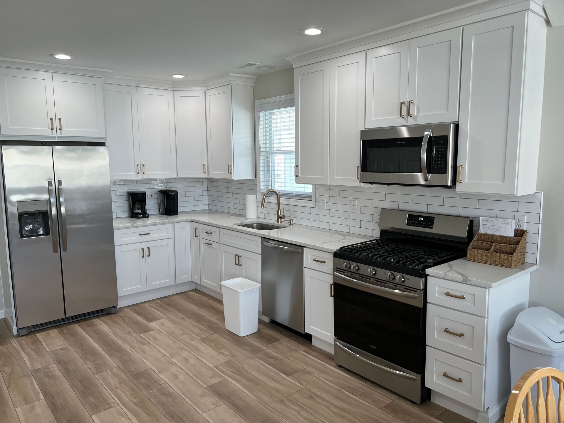 A kitchen with white cabinets and stainless steel appliances.