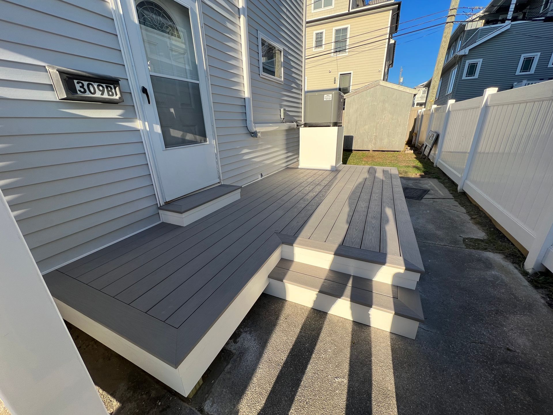 A house with a deck and stairs in front of it.