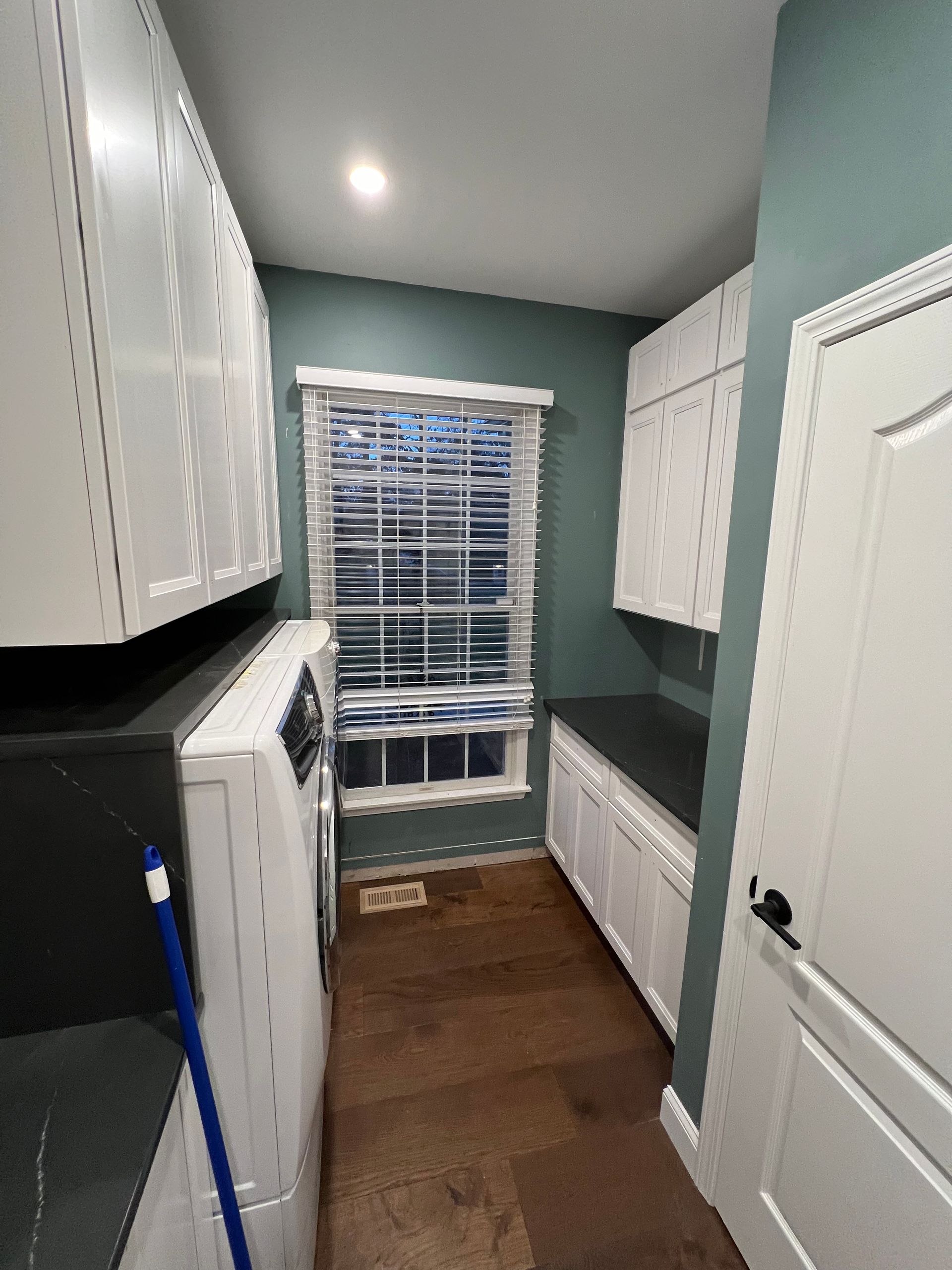 A laundry room with a washer and dryer and a window.