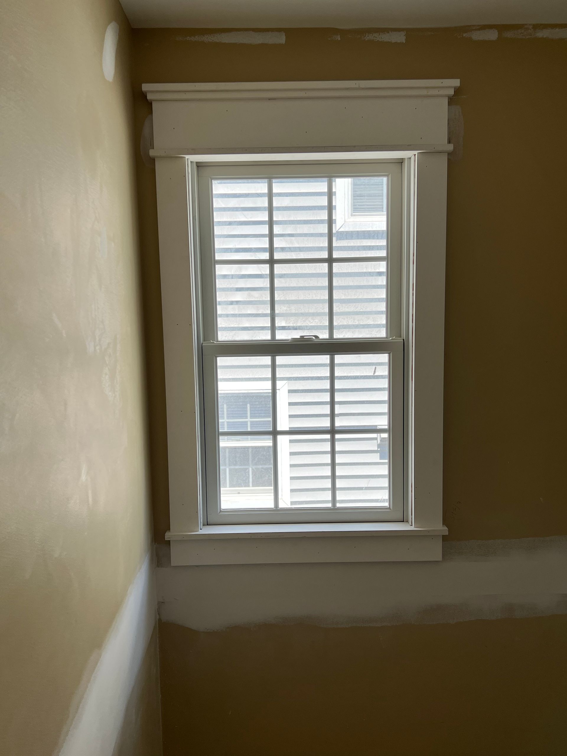 A window in a room with a white trim