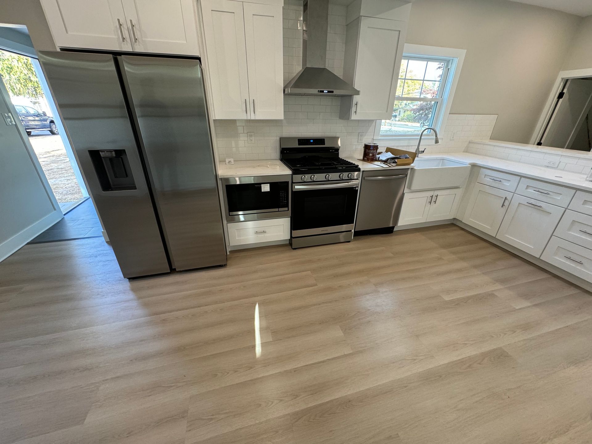 A kitchen with stainless steel appliances and white cabinets