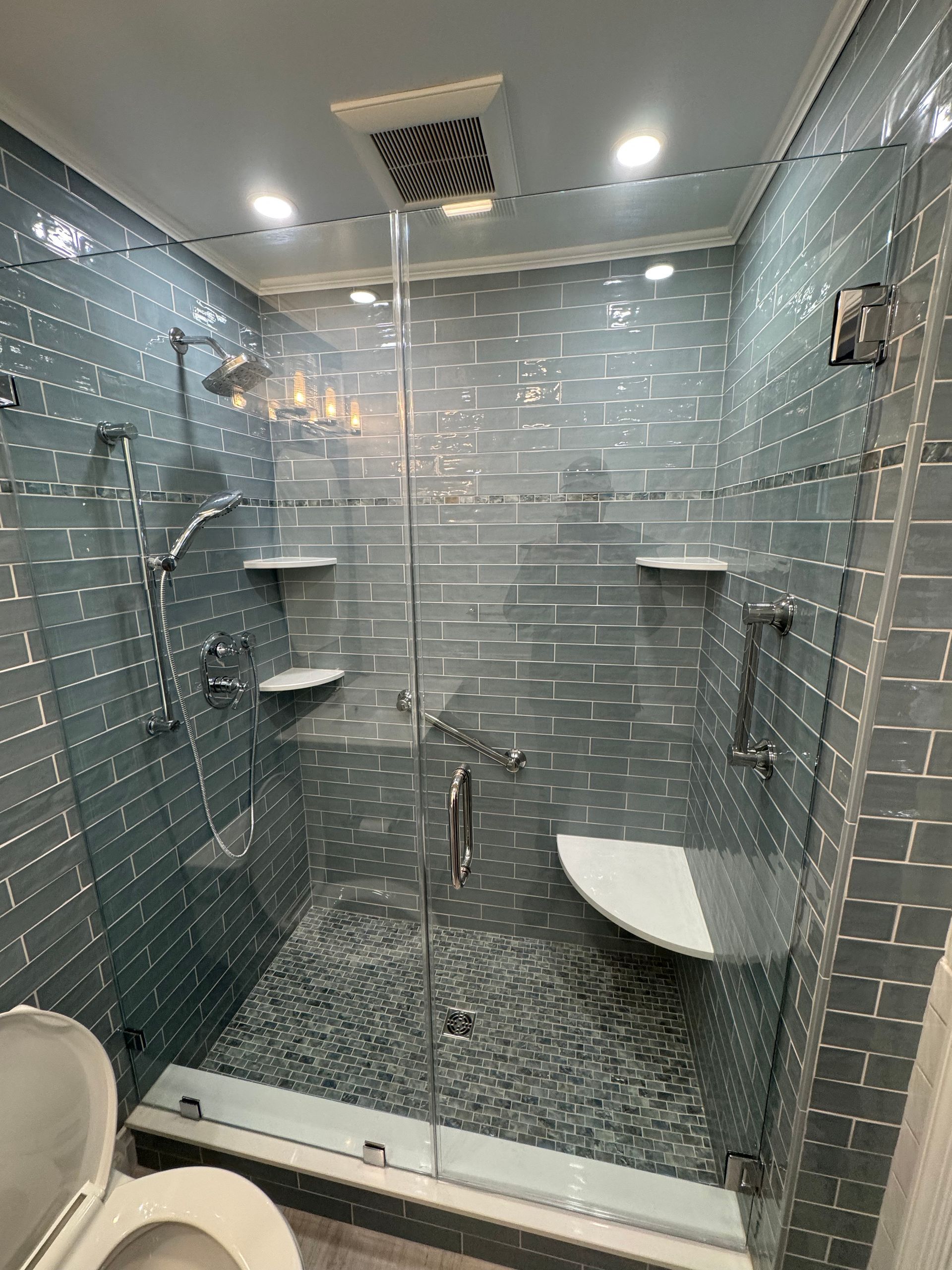 A bathroom with a walk in shower and a toilet.