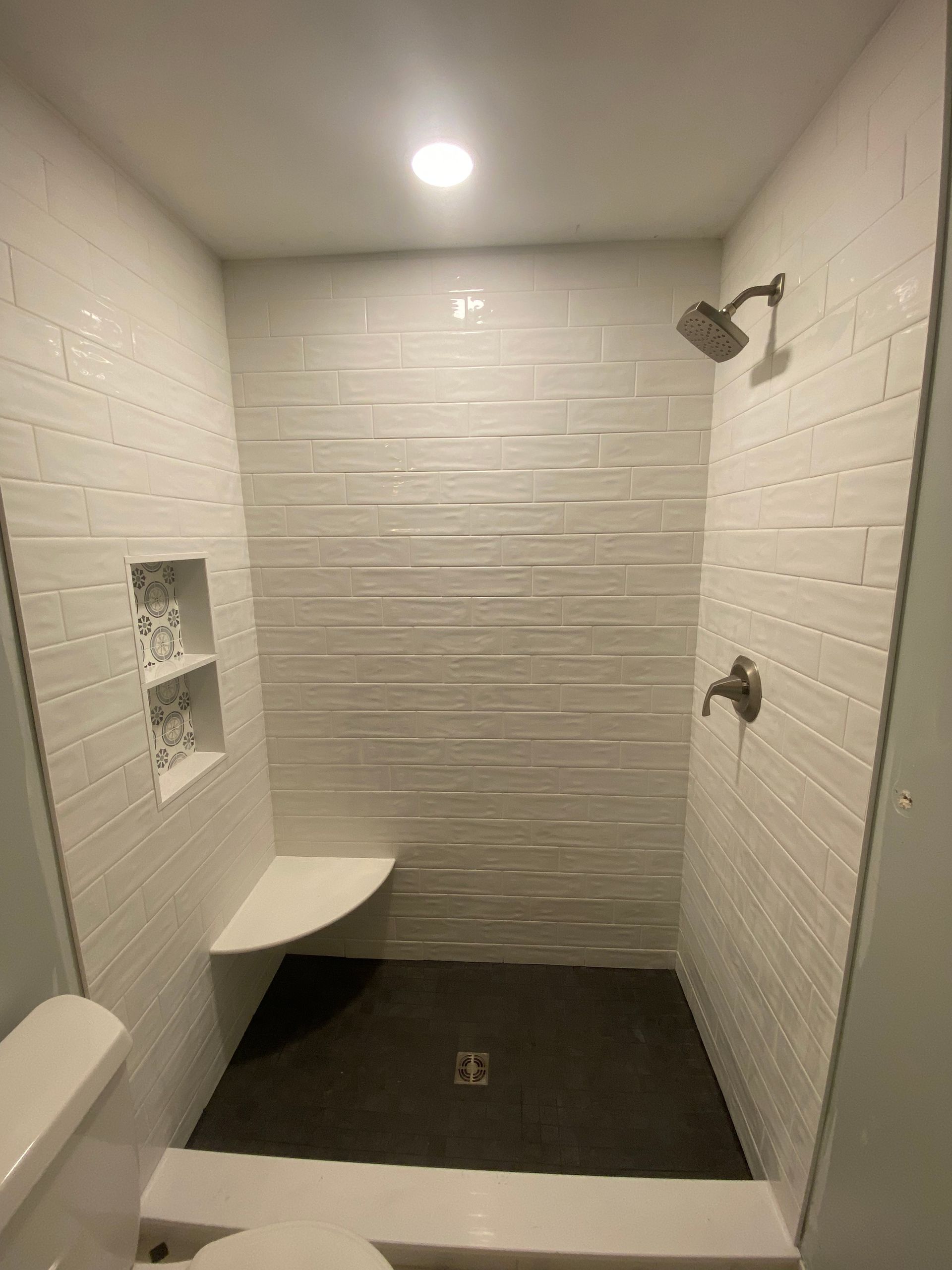 A bathroom with a walk in shower and a toilet.