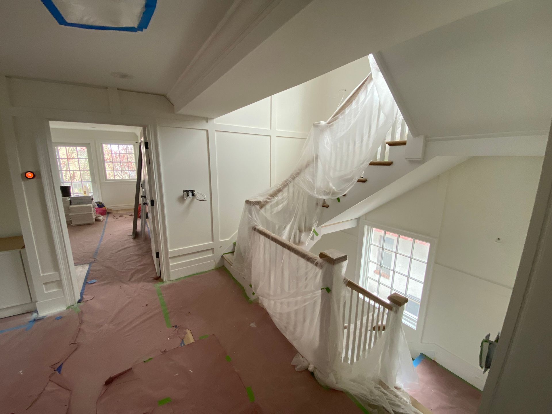 A staircase is being painted in a house.