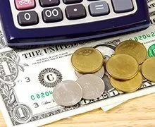 Money next to calculator — Indianapolis, IN — McManus & Associates