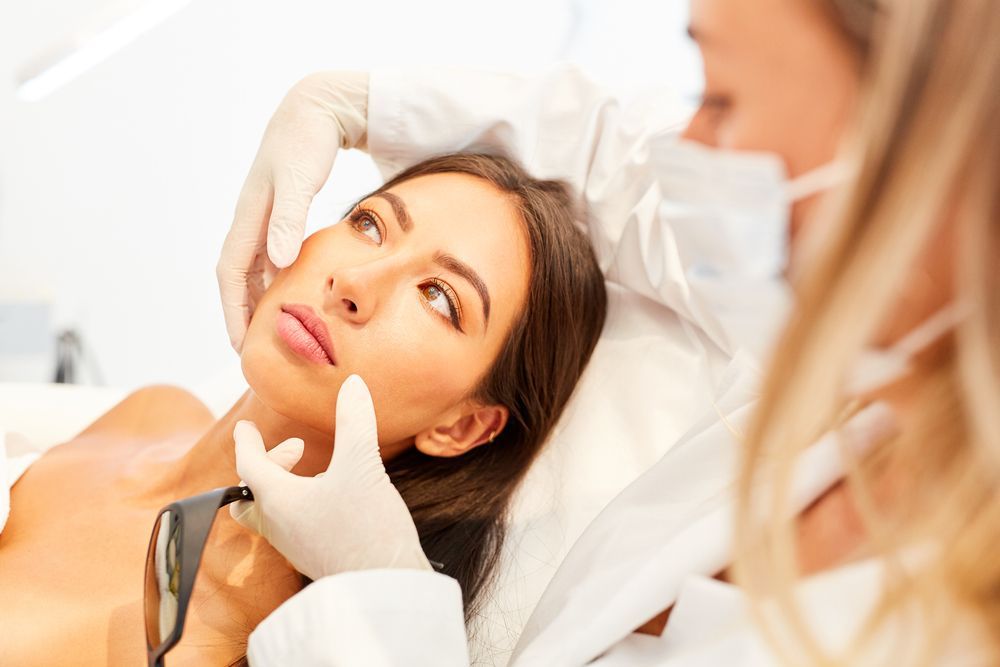 A woman is getting a botox injection in her face.