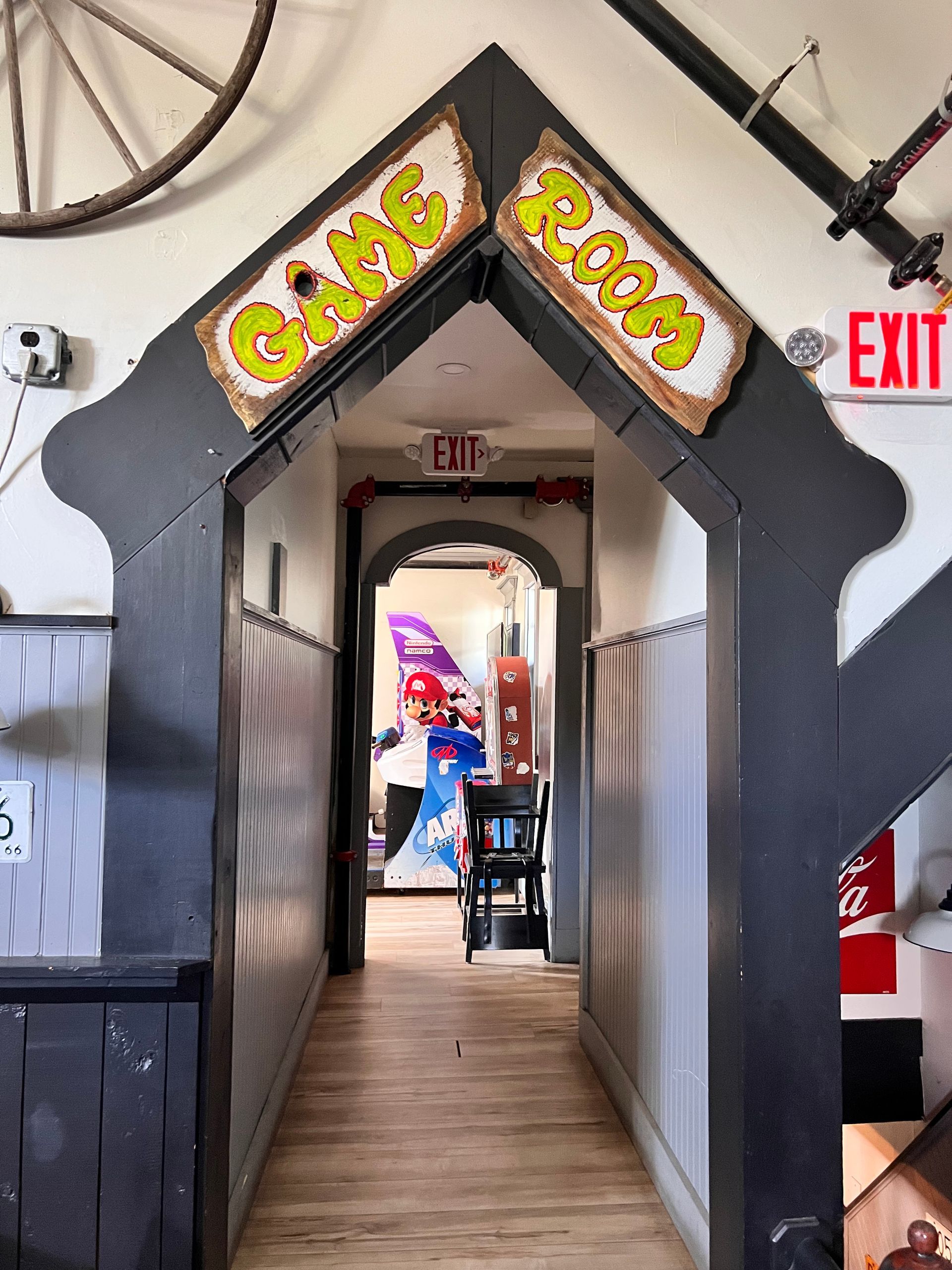 A hallway with a sign that says game room