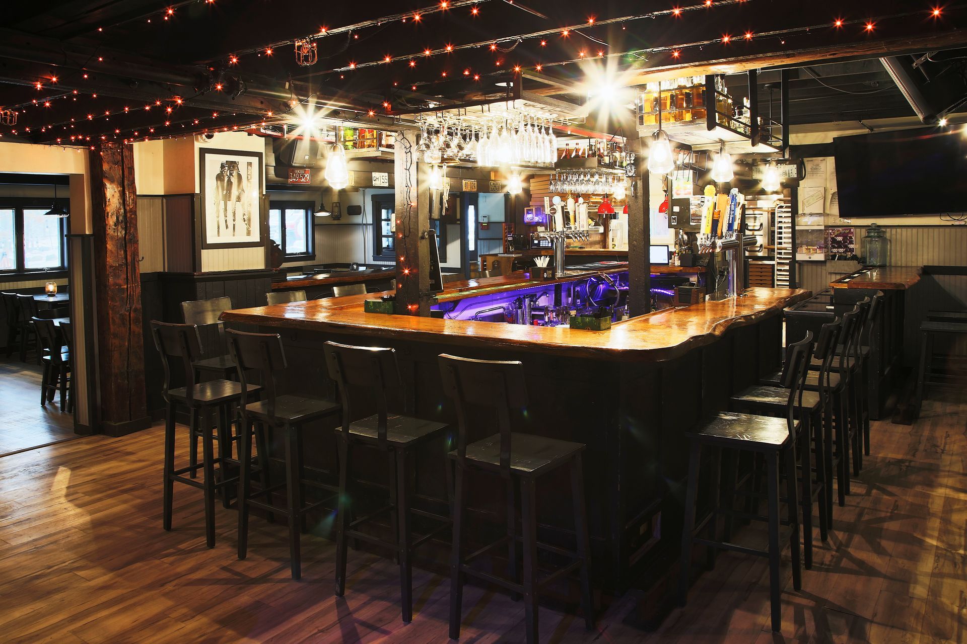 A long bar in a restaurant with a lot of chairs