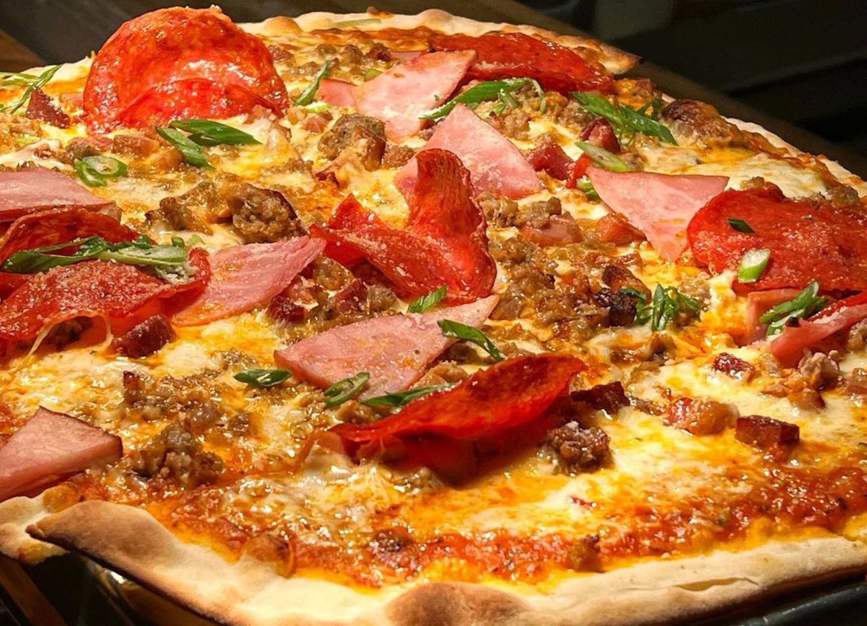 A pizza with a lot of toppings on it