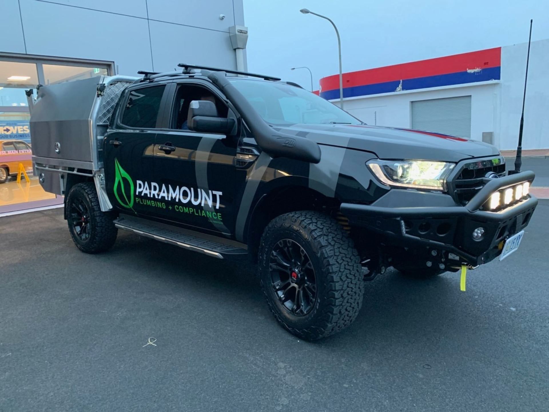 a man is working on a water heater in a basement.