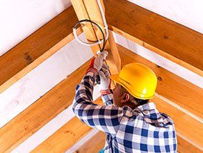 Commercial Electrician — Electrician Working With Wires At Attic Renovation Site in Fayetteville, NC