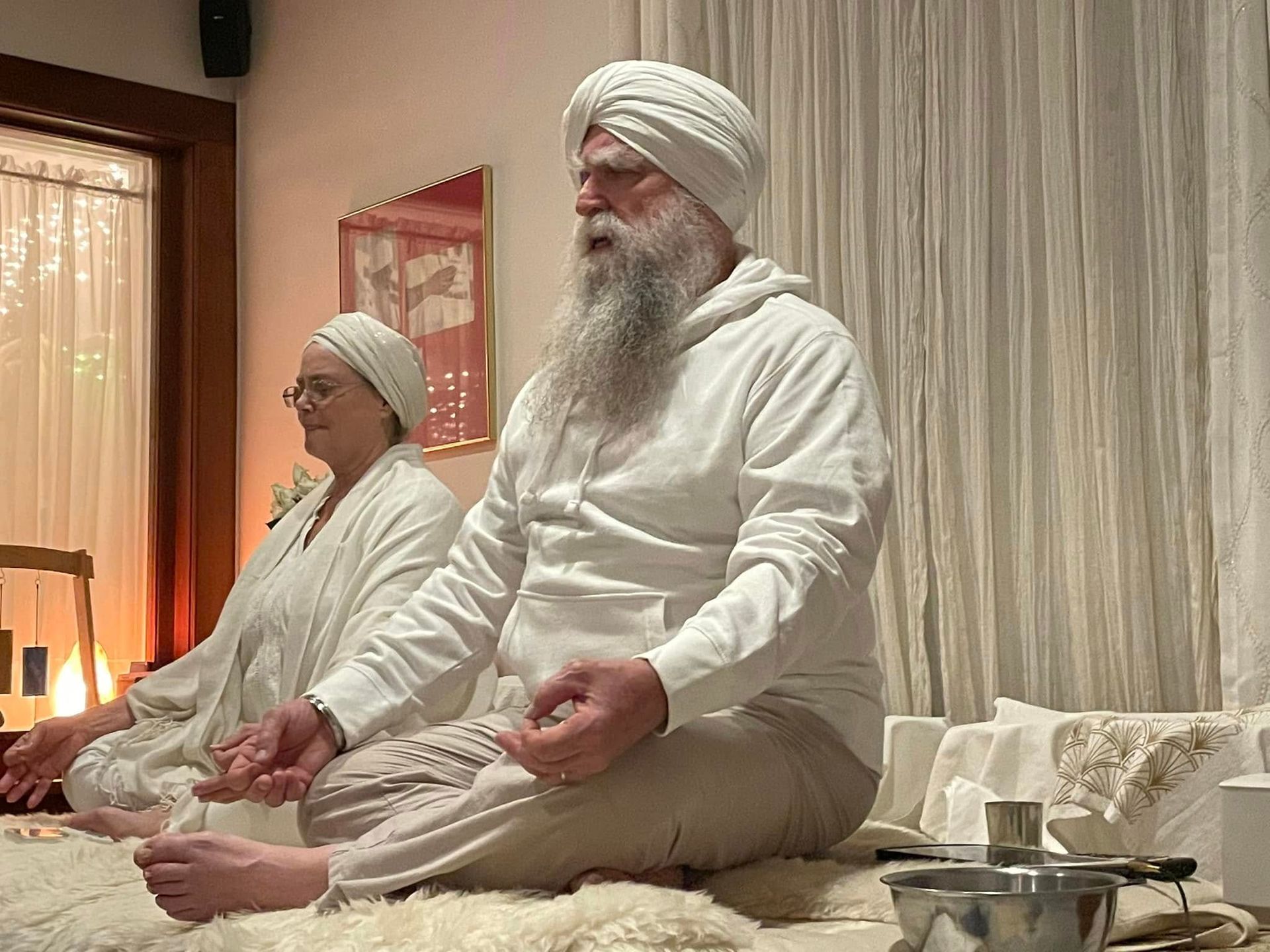 A woman is bending over on a yoga mat.