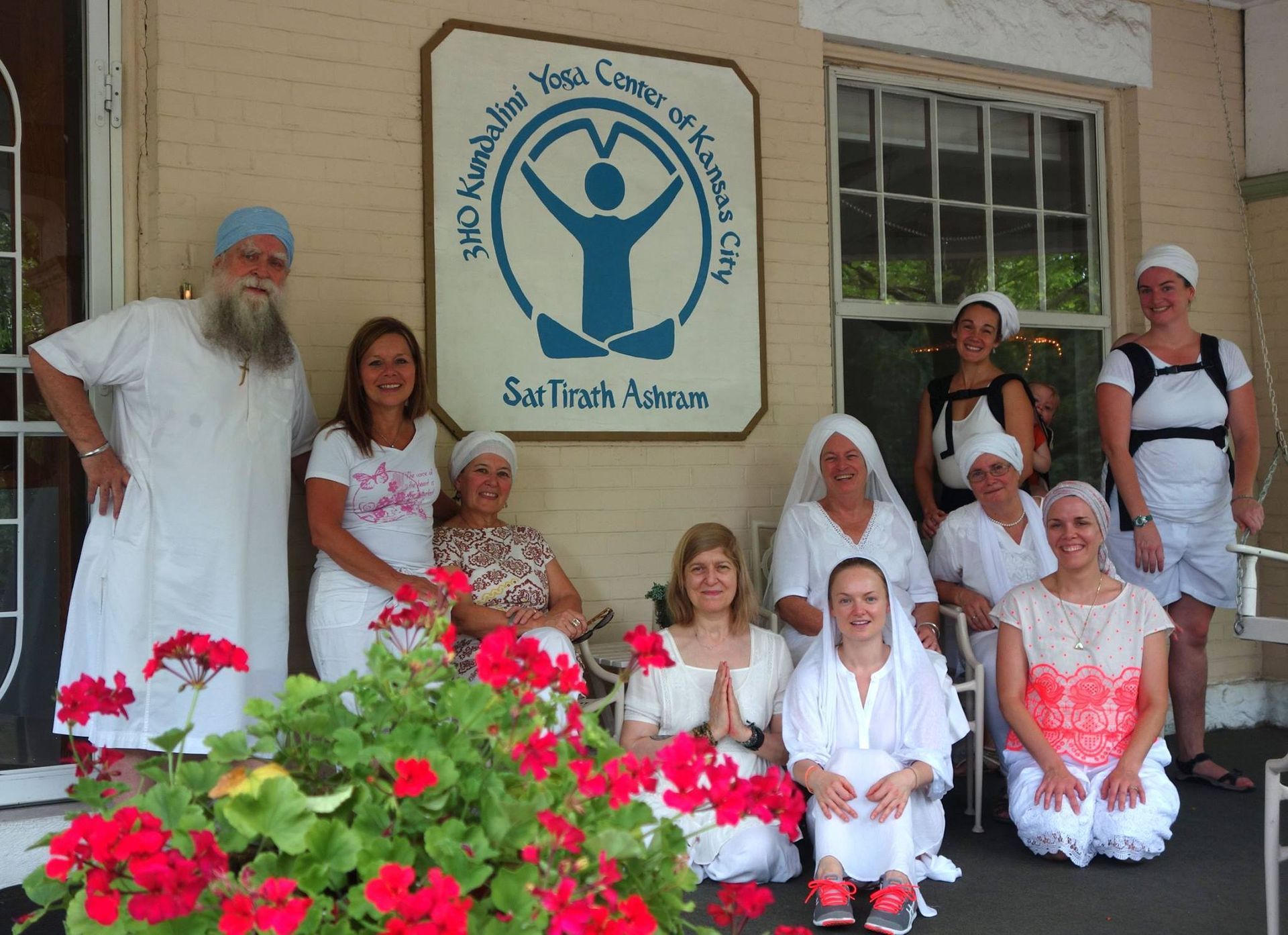 A group of people posing for a picture in front of a sign that says sad trash ashcans