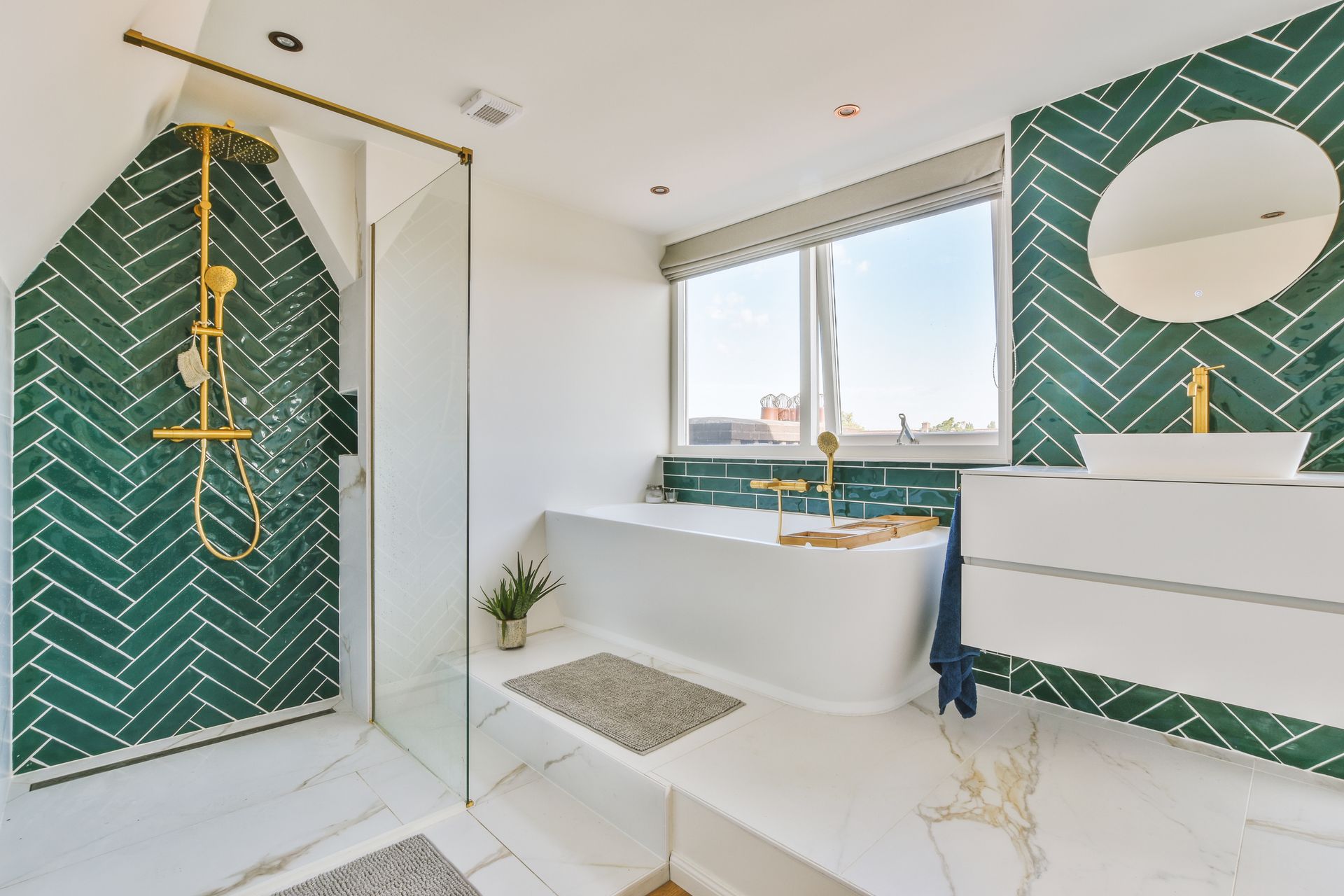 A bathroom with green tiles , a bathtub , a sink and a shower.