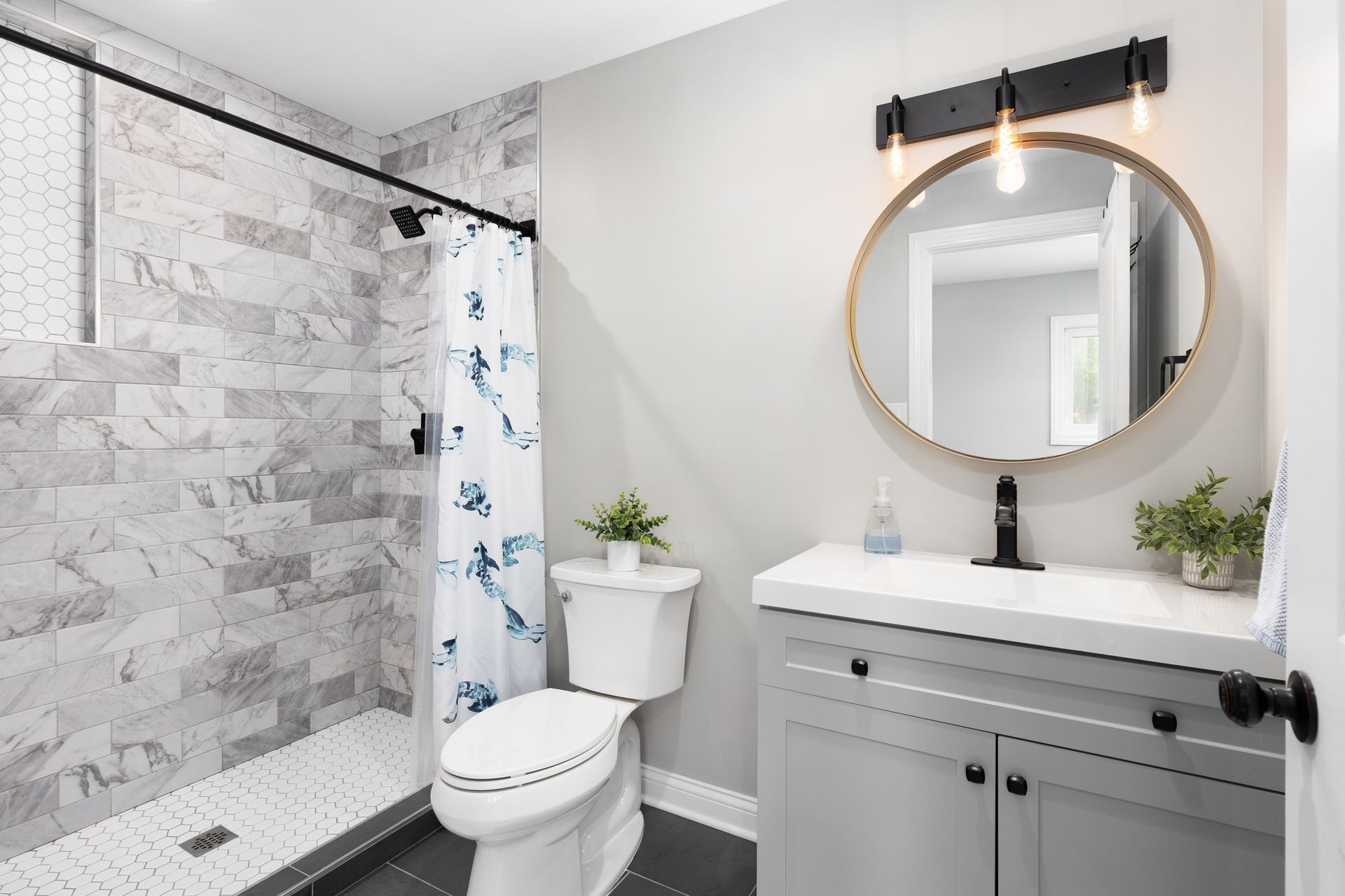 A tool bag filled with tools is under a sink in a kitchen.
