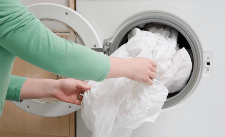 removing washed clothes from the washing machine