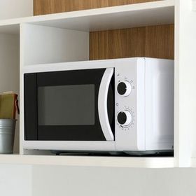microwave oven placed in a shelve
