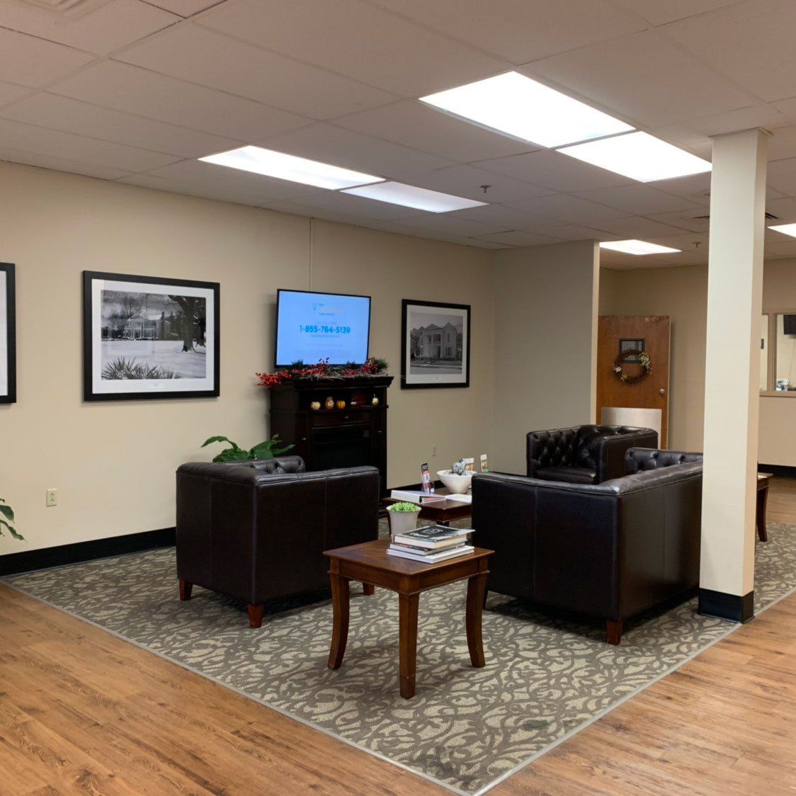 A living room with a couch and two chairs
