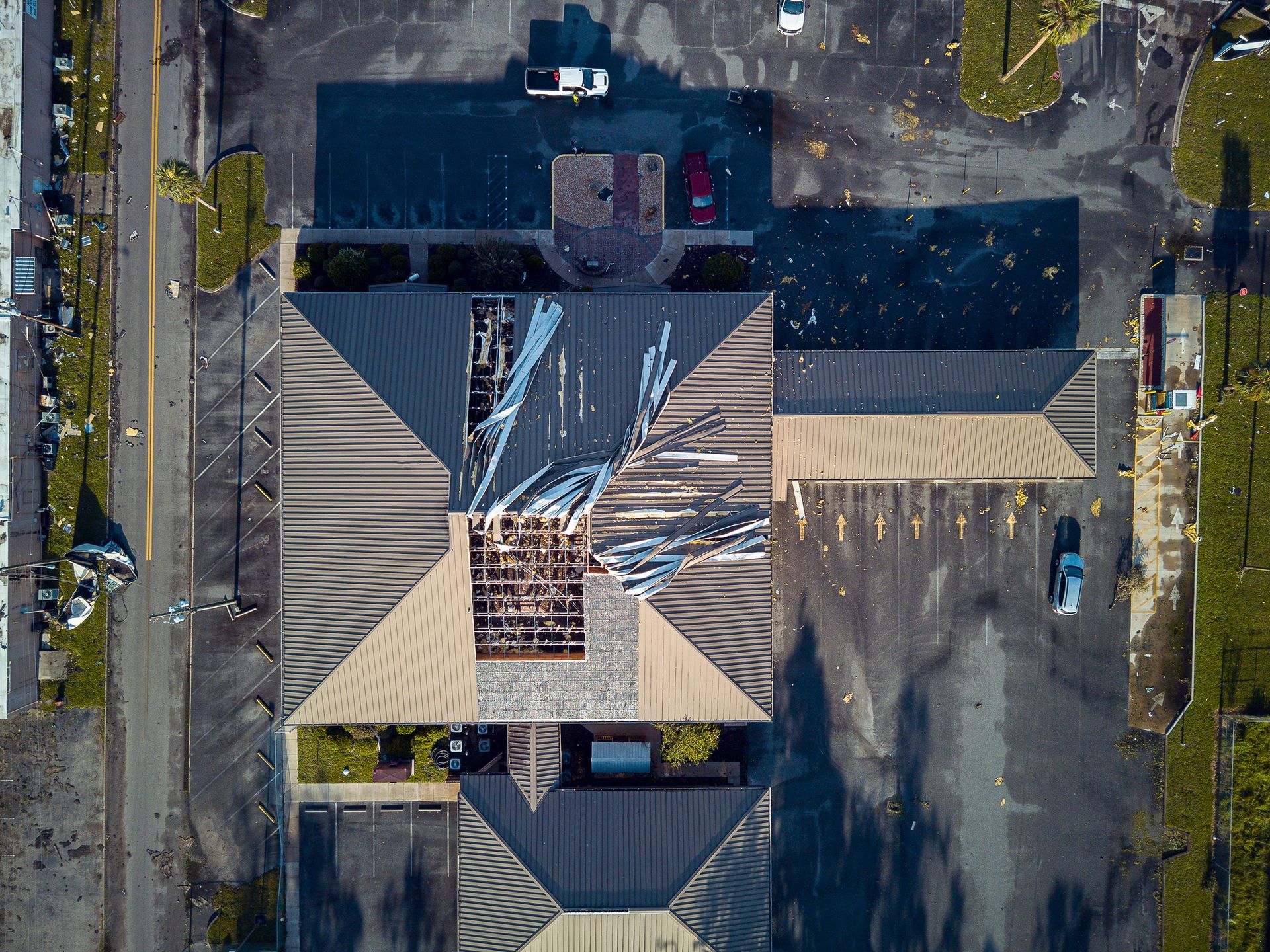 An aerial view of a building with a damaged roof