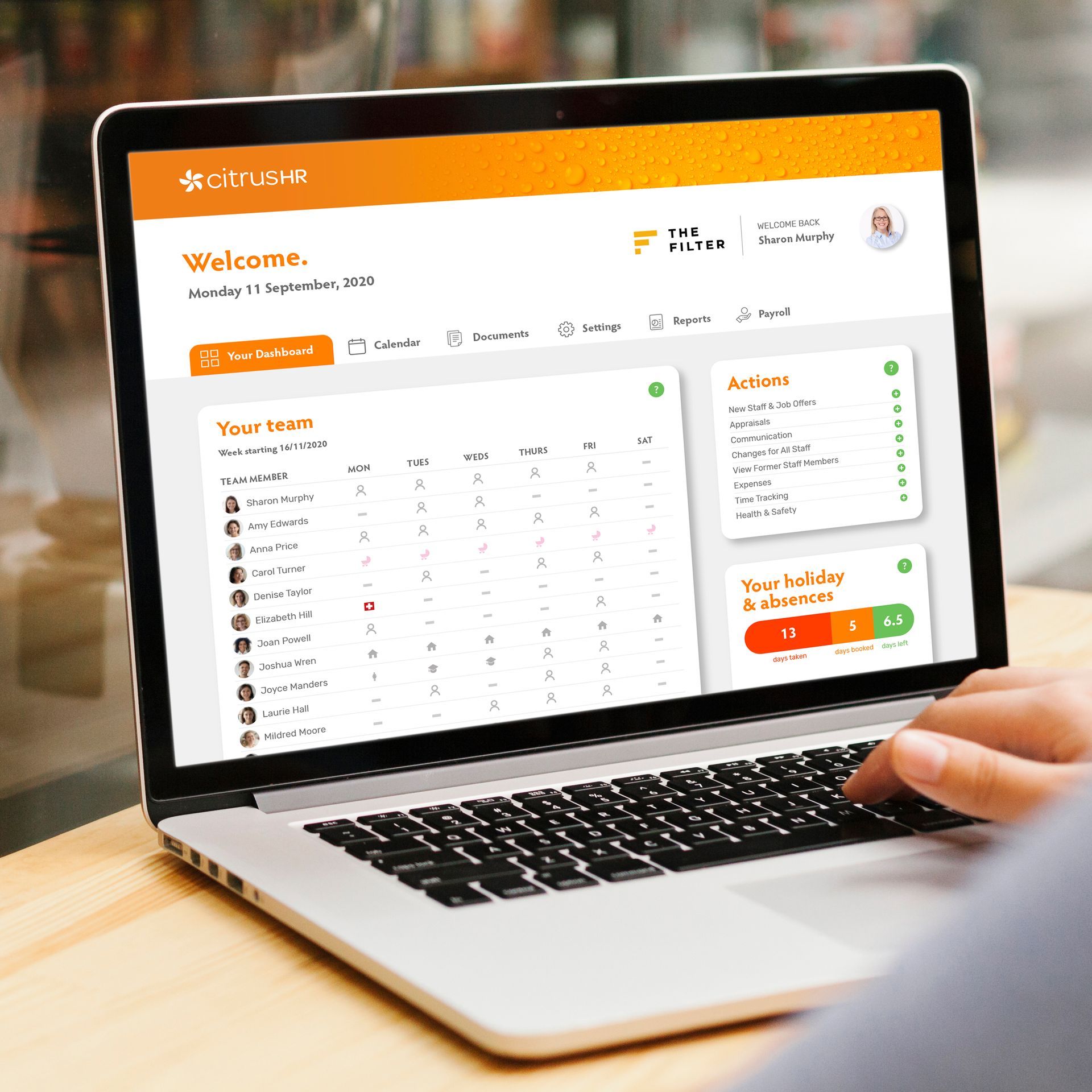 A person is using a laptop computer with a welcome page on the screen.