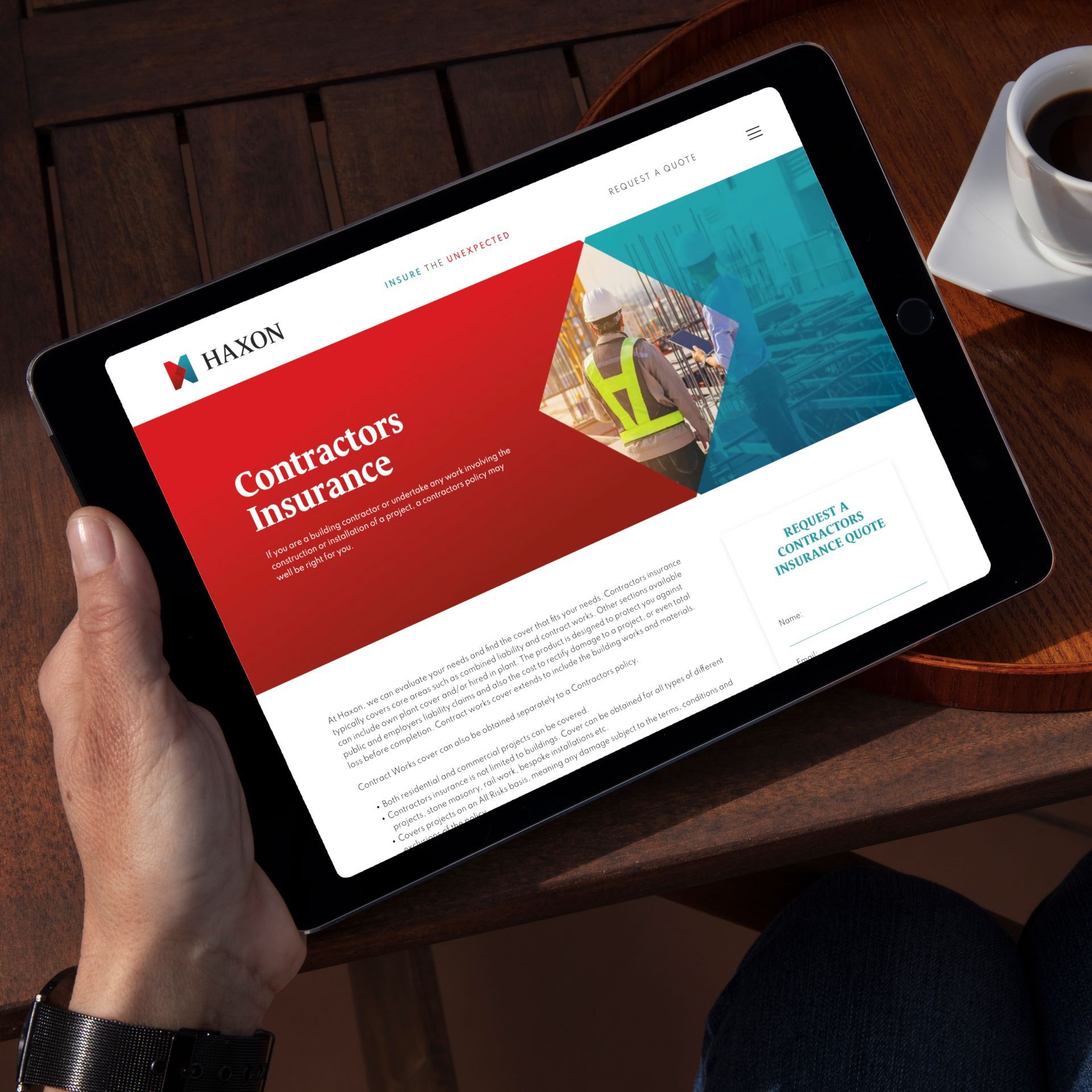 A person is holding a tablet that says contractors insurance