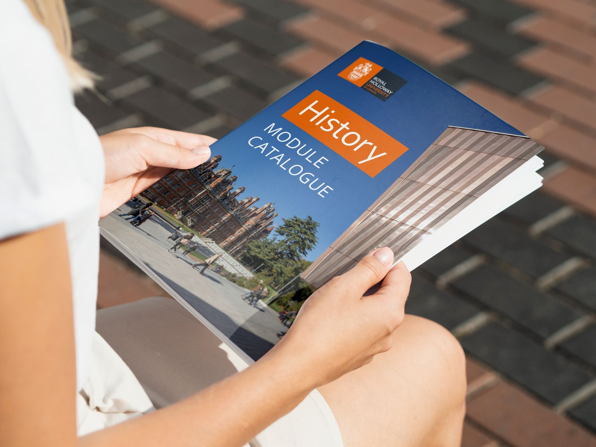 A woman is reading a history module catalogue