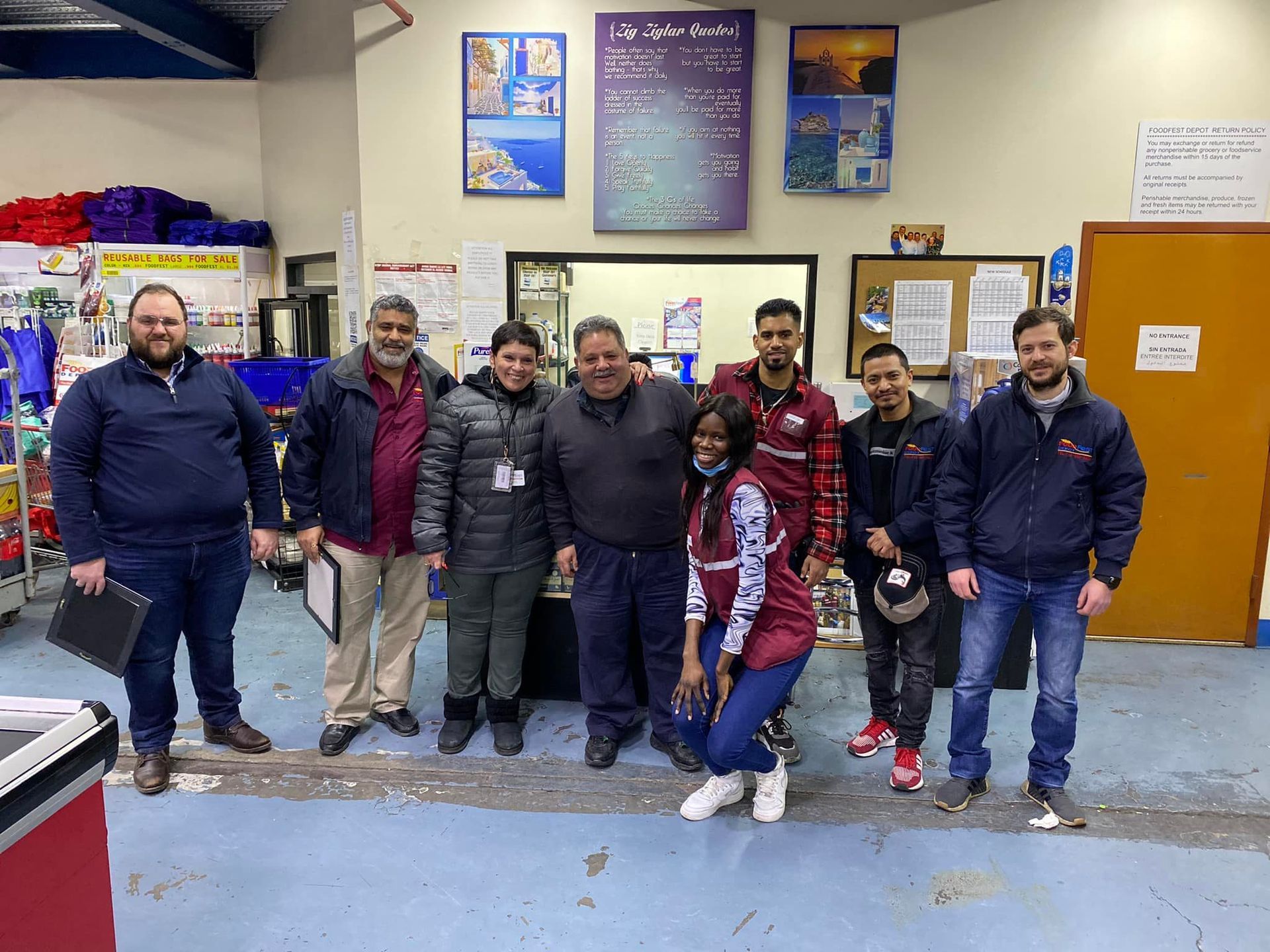 A group of people are posing for a picture in a room.