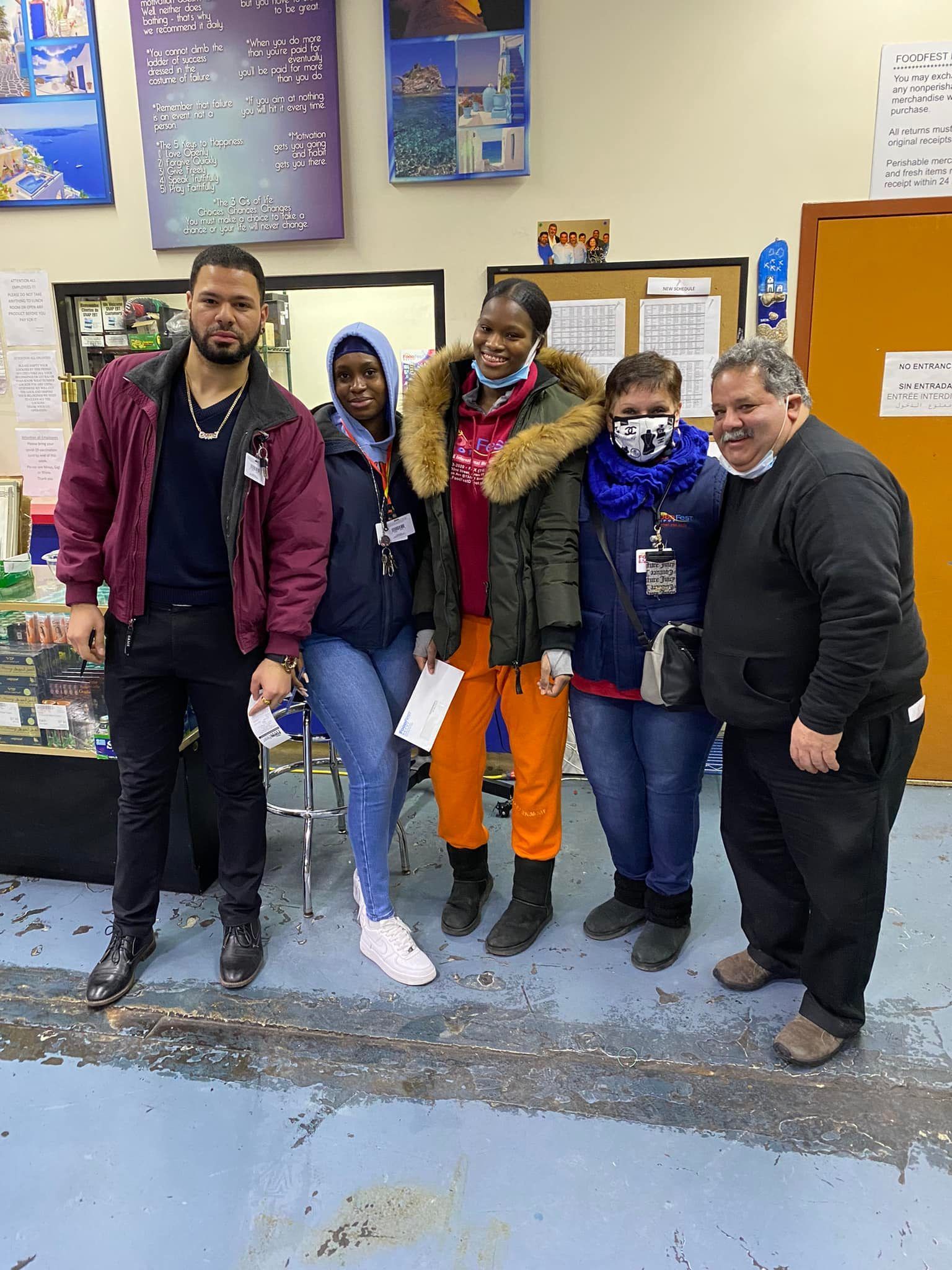 A group of people are posing for a picture in a room.